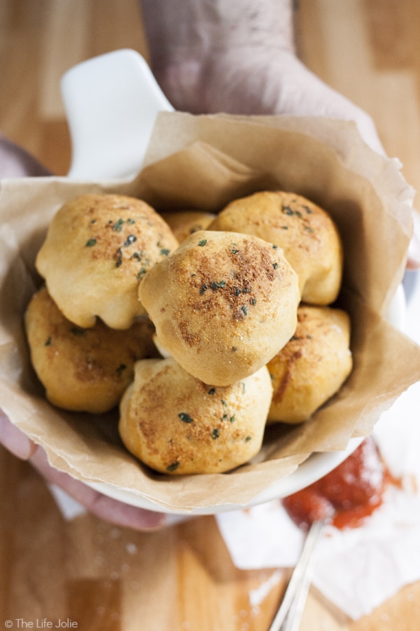 This Meat Lover's Pizza Bites recipe is the ultimate game day appetizer! Pepperoni, sausage, bacon and melted cheese, enveloped in a warm biscuit and dipped in tomato sauce. These homemade snacks will be a welcome addition to any tailgate party!