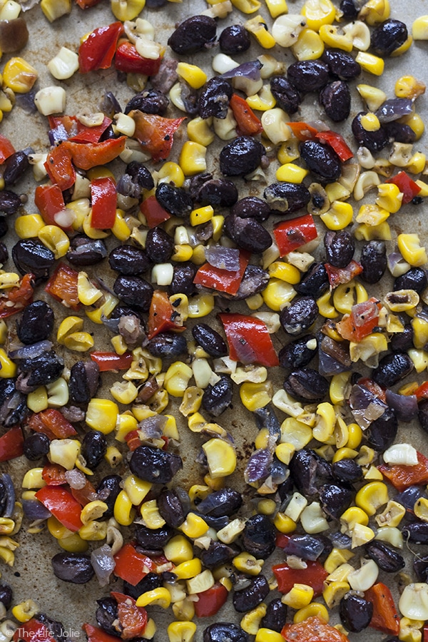 This Roasted Corn Salsa recipe is an easy and healthy addition to a salad, meat based dinner entree or eggs in the morning. It's homemade with black beans, fresh corn, onions and peppers- I seriously love this so much I now keep a container of it in my refrigerator to use throughout the week!