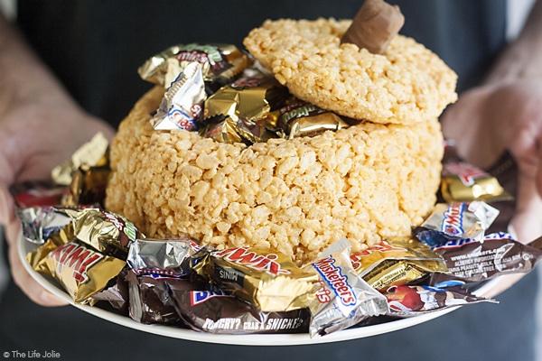 This Rice Krispie Treat Pumpkin is the perfect addition to your holiday table. It's an easy, kid friendly dessert that looks awesome filled with candy and is so much fun for a Halloween party or Thanksgiving!