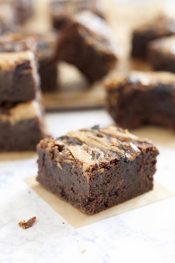 These homemade PB&J Brownies are an easy and delicious holiday dessert option. Chewy, fudgey chocolate brownies with a swirl of peanut butter and the fruit spread of your choice on top, these are made from scratch and would be great on a Thanksgiving of Christmas dessert table or just because you deserve a tasty dessert!
