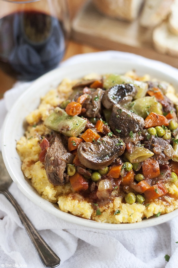 This Slow Cooker Italian Beef Stew recipe is one of my favorite easy comfort food meals. With tender meat, vegetables, tomatoes (and a little bit of wine for good measure!) this tastes fantastic served over potatoes, pasta or polenta with a nice, crusty piece of bread!