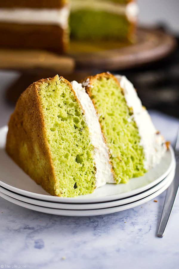 This Lemon Pistachio Cake is the best easy recipe when you need a quick cake to wow your guests. This is actually a hack for a box cake mix made with pudding and topped with light and fluffy whipped cream. The result is a super moist and pretty layered cake that is so good your guests will never guess that it's only halfway homemade!