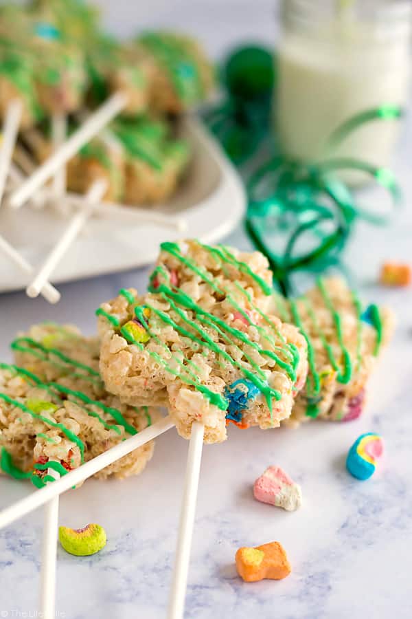 These Lucky Charms Treats are a super easy and fun dessert recipe to celebrate St. Patrick's Day with the kids! They're made with Rice Krispies and the marshmallows from Lucky Charms and drizzled with white chocolate that's been dyed green. These snacks are such a fun option to bring to parties and get-togethers!