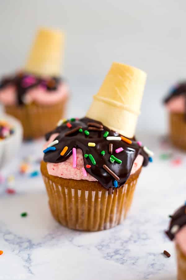 These Melted Ice Cream Cone Cupcakes are such a fun and easy dessert recipe. This tutorial is a delicious combination of moist vanilla cupcakes, strawberry frosting, chocolate and sprinkles! They are perfect to serve at your next party!
