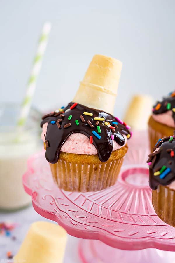 These Melted Ice Cream Cone Cupcakes are such a fun and easy dessert recipe. This tutorial is a delicious combination of moist vanilla cupcakes, strawberry frosting, chocolate and sprinkles! They are perfect to serve at your next party!