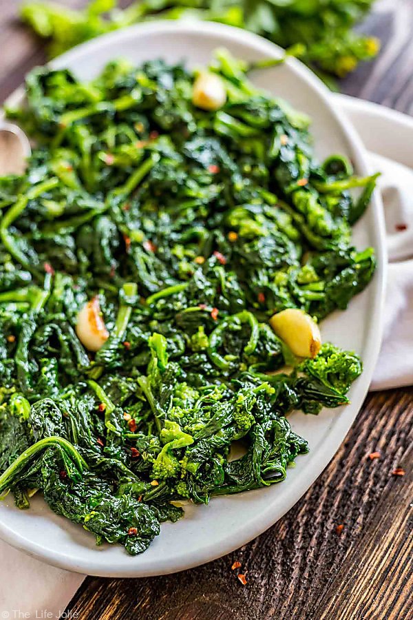 A plate of Broccoli RAbe with Garlic on an oval plate with the left side of the plate cut off.