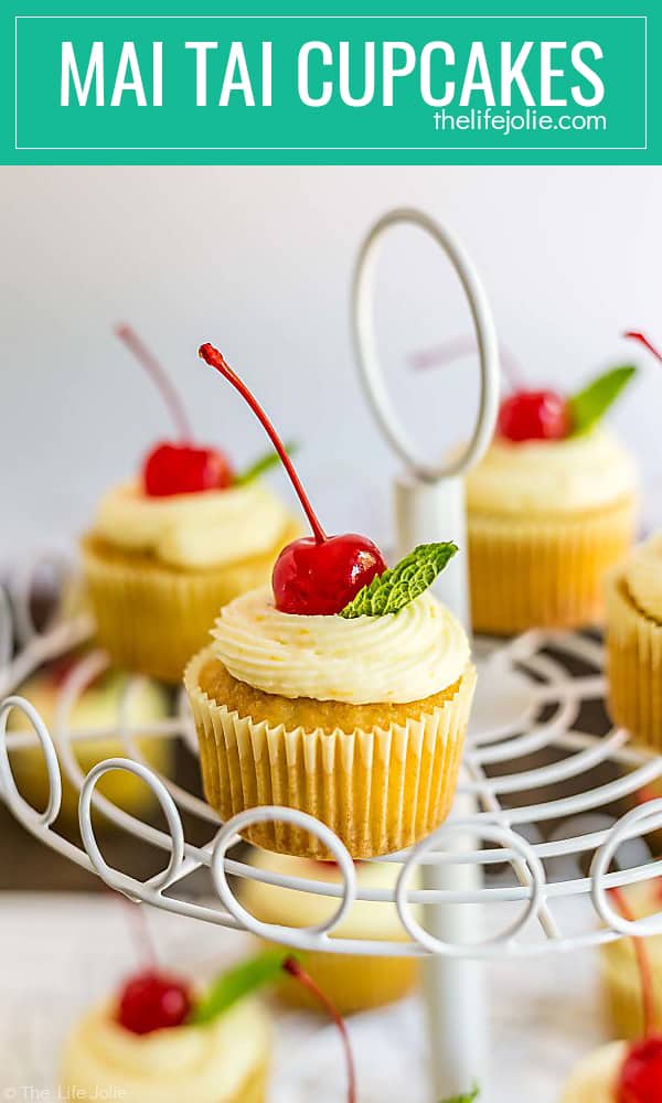 These Mai Tai Cupcakes are an easy and delicious recipe inspired by the cocktail. There's a small amount of rum (not a ton, there are kid-friendly) in the cupcakes which makes them super moist and they're topped with a fresh orange butter cream that's bursting with flavor and a cherry and a sprig of mint on top, just like the drink!