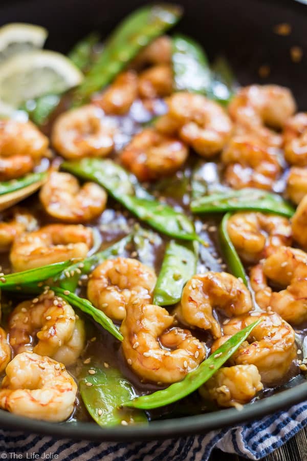 A close up image of Shrimp and Snow Peas Stir Fry in a pan.