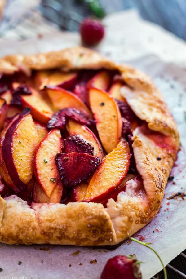A close up image of a Nectarine and Strawberry Galette with Thyme.