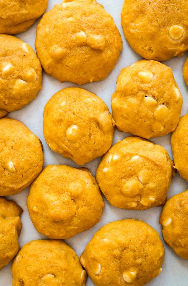 An overhead image of White Chocolate Macadamia Nut Pumpkin Cookies laid out.