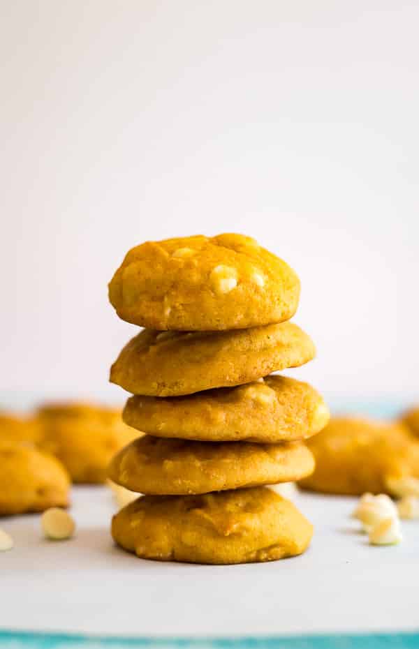 A straight on shot of White Chocolate Macadamia Nut Pumpkin Cookies with other cookies behind it out of focus.
