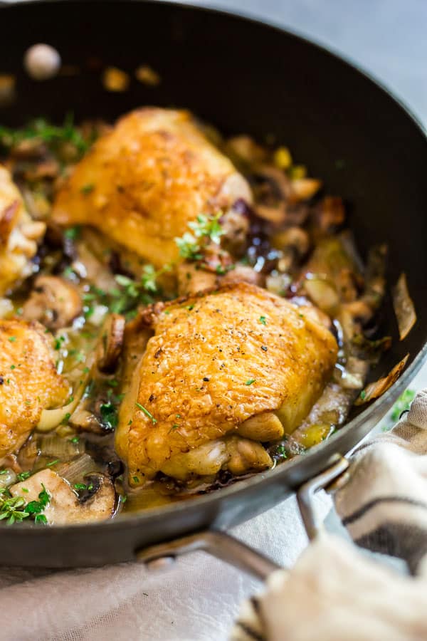 A close up shot of Champagne Braised Chicken Thighs in a pan.