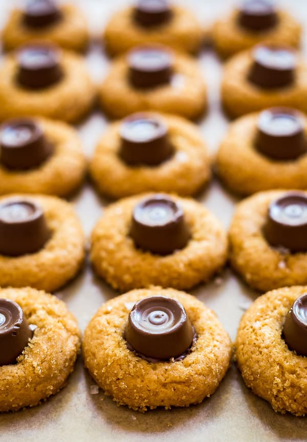 Salted Caramel Blossoms Cookies lined up on a pan.