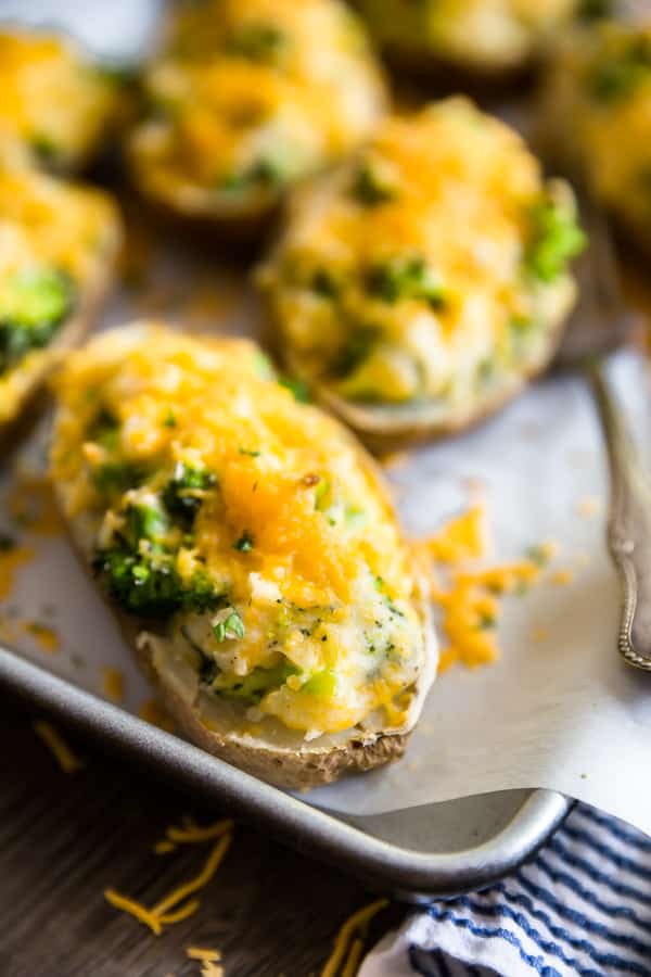 A close up of a Cheddar and Broccoli Twice Baked Potato on a pan.