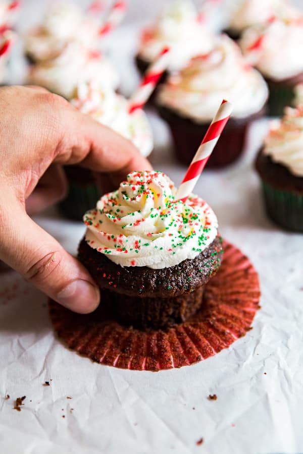 A hand taking one of the Peppermint Hot Chocolate Cupcakes.