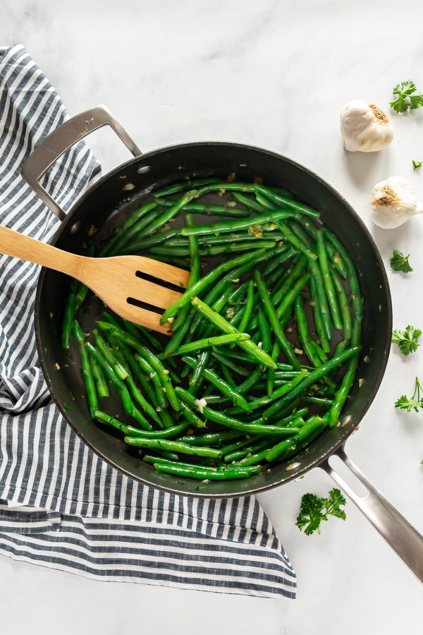 An overhead image of green beans in a saute pan.